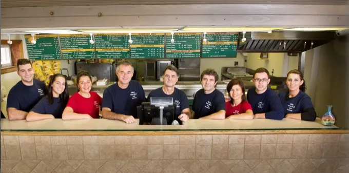 A restaurant team behind their counter